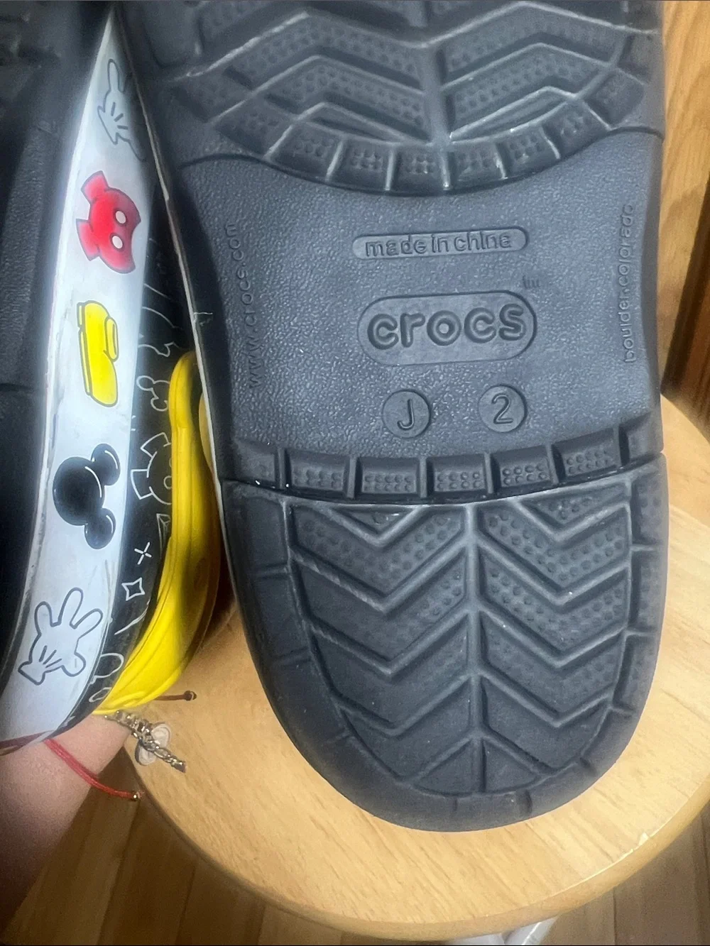 CROCS Kids Black Clogs with Yellow Heel Straps and White Doodle Prints